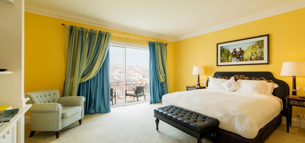 Luxury bedroom with blue blackout curtains and yellow walls in Dubai